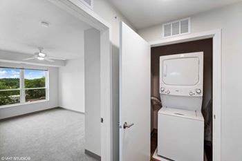 a laundry room with a washer and dryer in an empty room